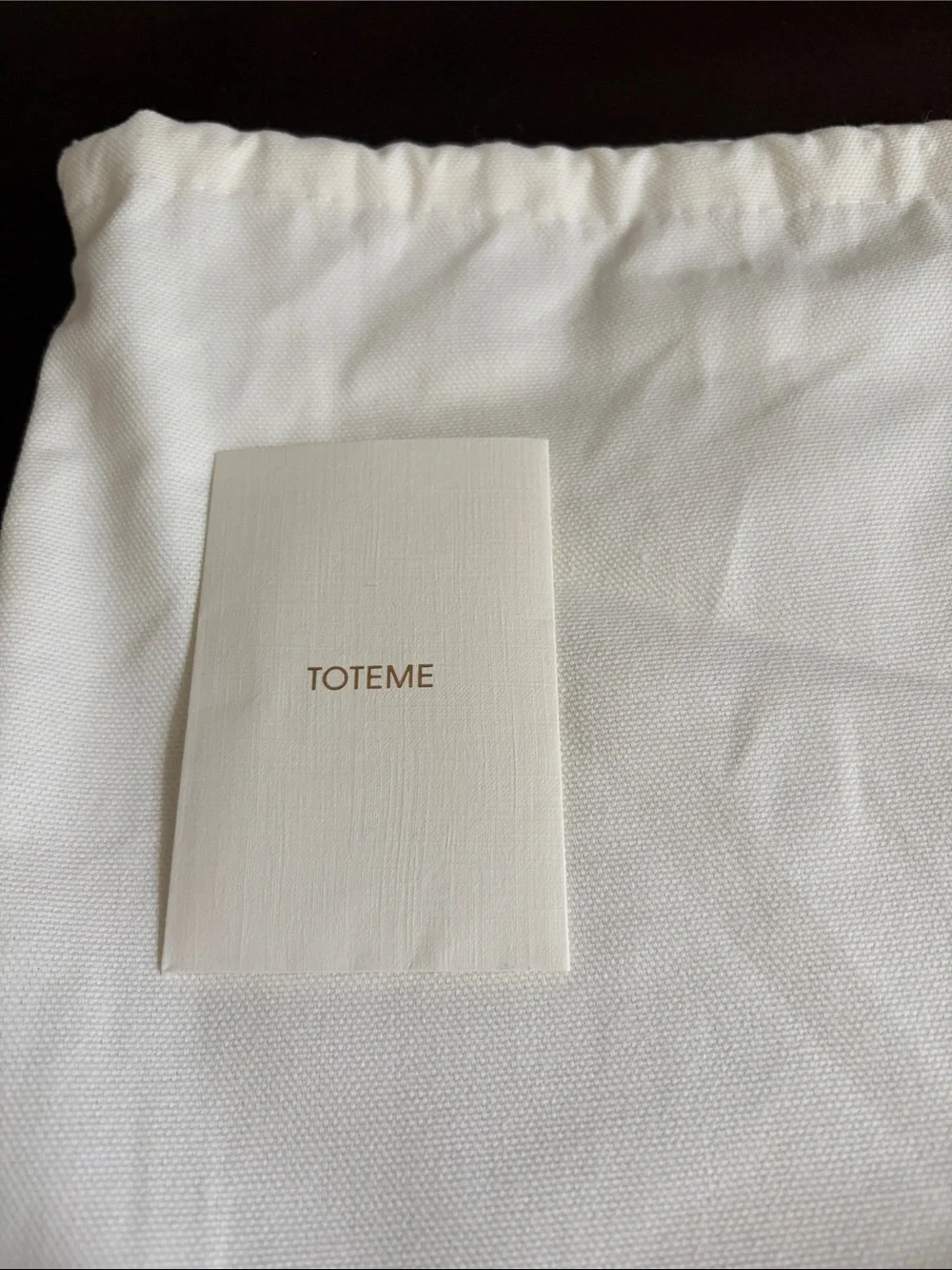 Toteme Dark Taupe  Leather Pebbled Clutch with Silver-Tone T Closure .